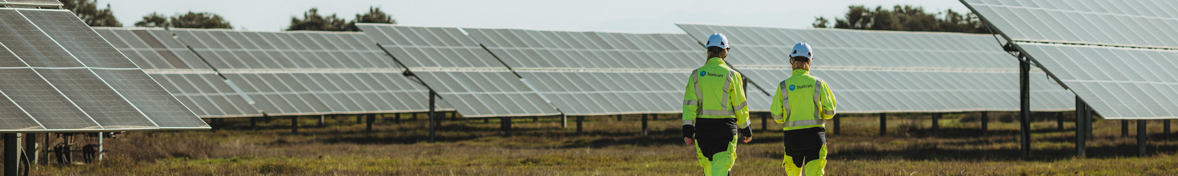 Women walking in solar farm